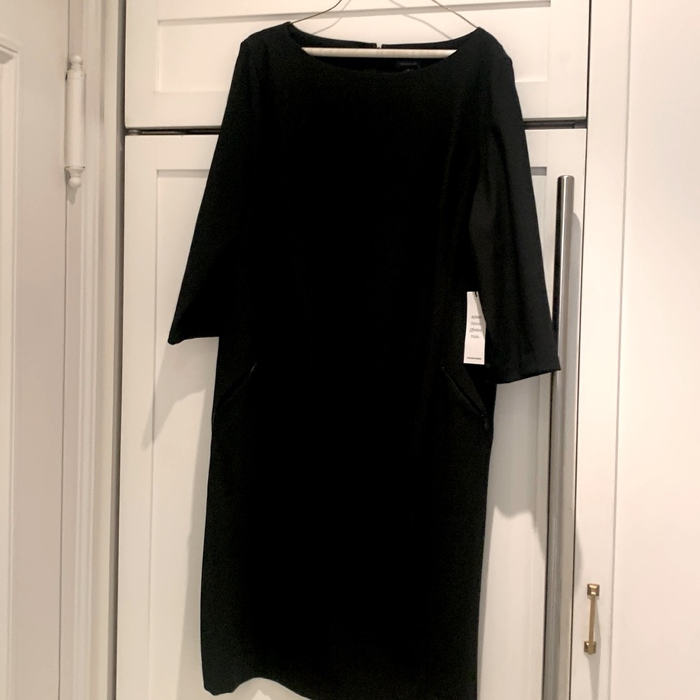 Never worn with tags beautiful and elegant black dress. Wear formal or to work!